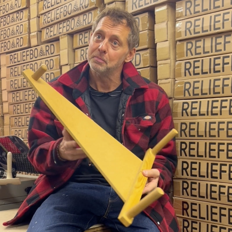 The inventor of the Reliefboard holding the first wooden prototype.