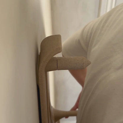 A video showing a woman in a white tshirt leaning back against the Reliefboard and showing how the peg targets a muscle on her back.
